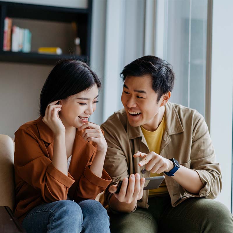 Happy couple looking on the tablet how to sell a house fast, 3-Step Home Buyer